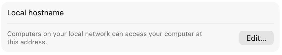 Local hostname row at the bottom of the Sharing pane in macOS System Settings, with the note Computers on your local network can access your computer at this address, and an Edit button.